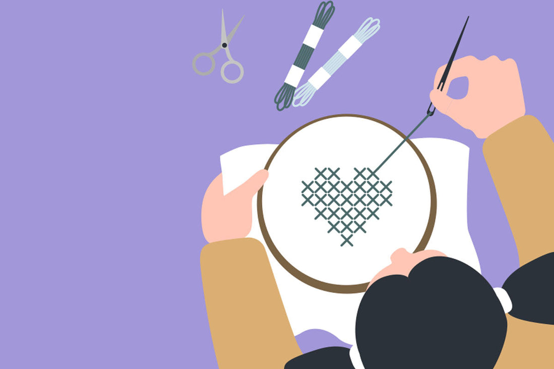 Illustration of a person stitching a heart pattern on fabric using a cross stitch hoop, with embroidery floss and scissors nearby, representing creativity and mindfulness.