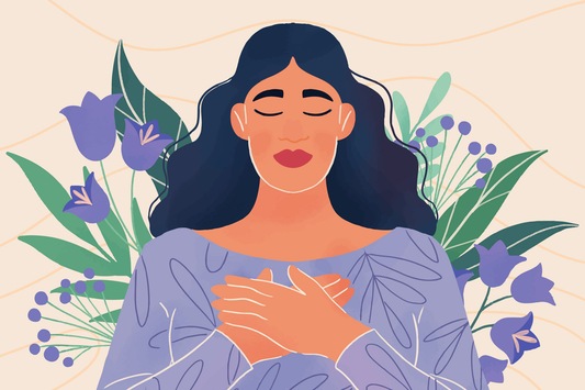 A woman with black hair, eyes closed, holding her hands on her heart signifying gratitude.